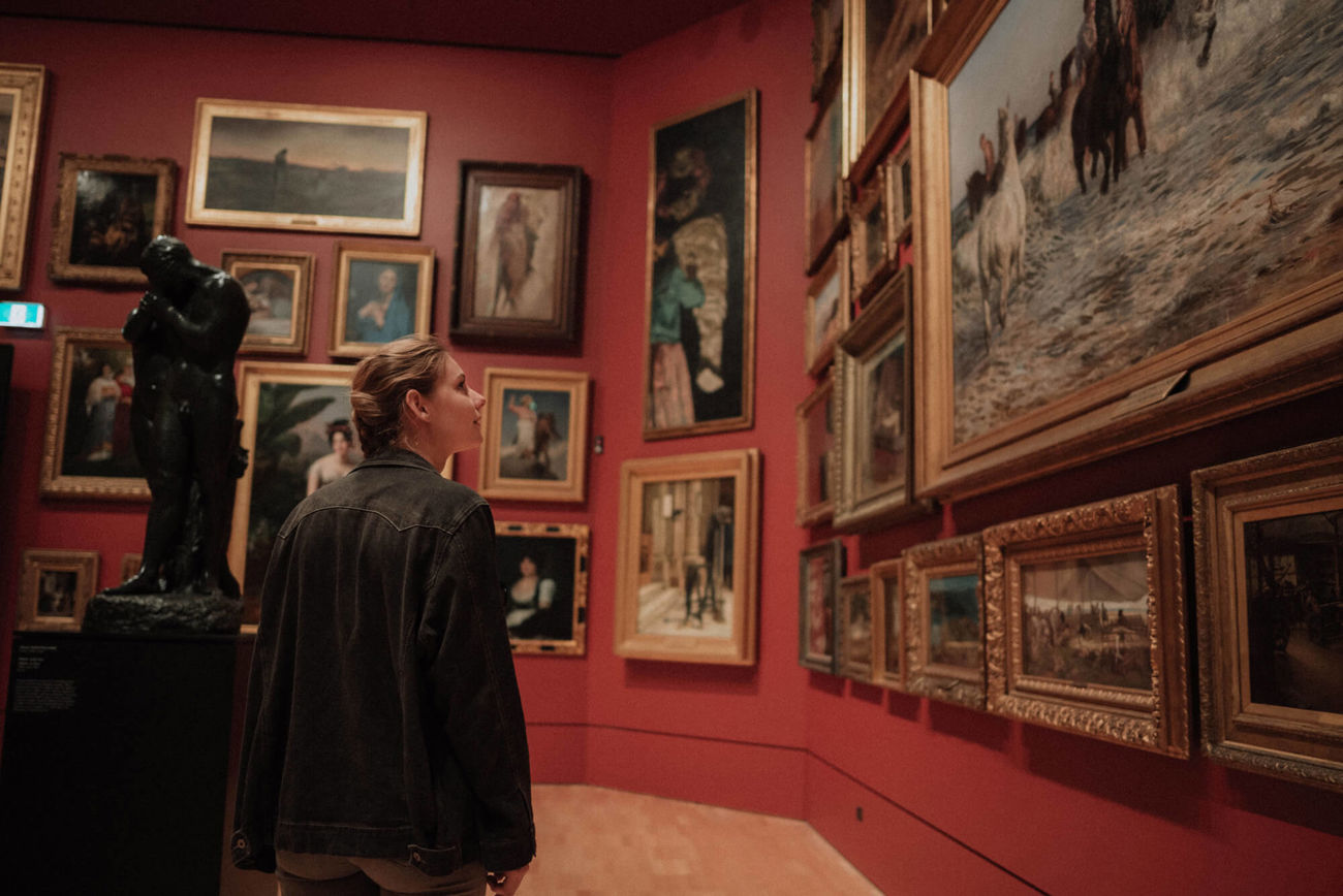 Woman looking at painting in art gallery