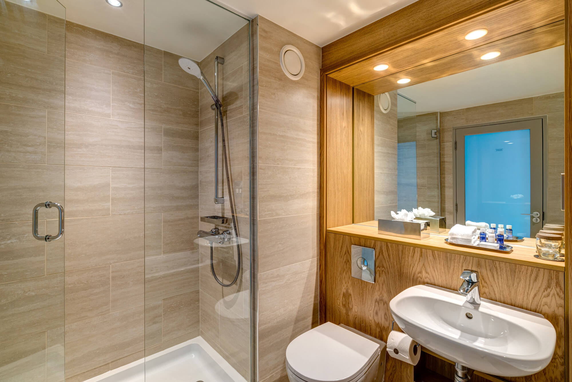 Walk-in shower next to sink in bathroom