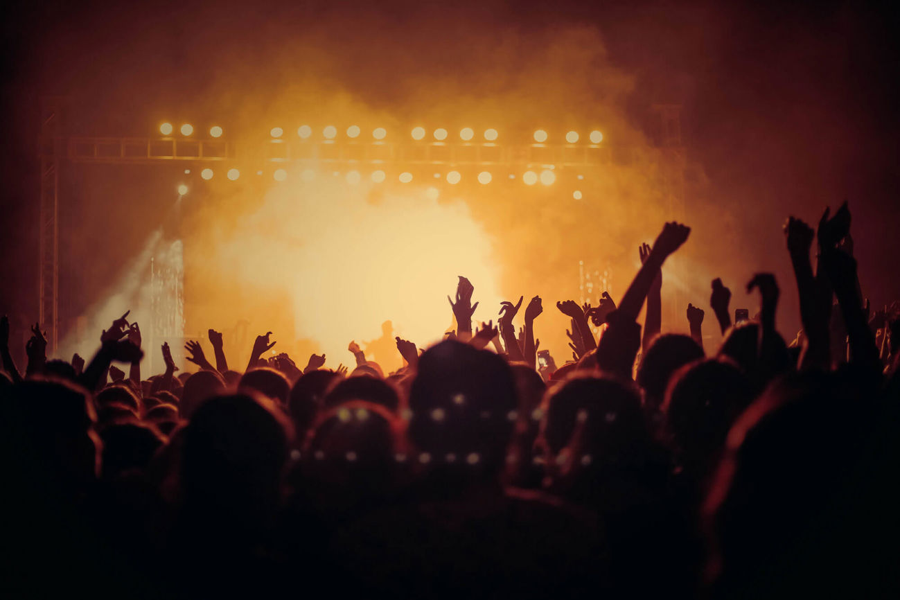 Crowd with arms in the air at concert
