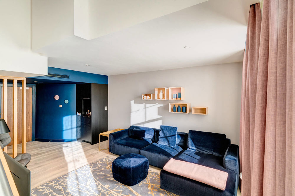 Duplex Suite at Apex Waterloo Place Hotel Duplex Suite living area with blue velvet corner sofa at Apex Waterloo Place Hotel