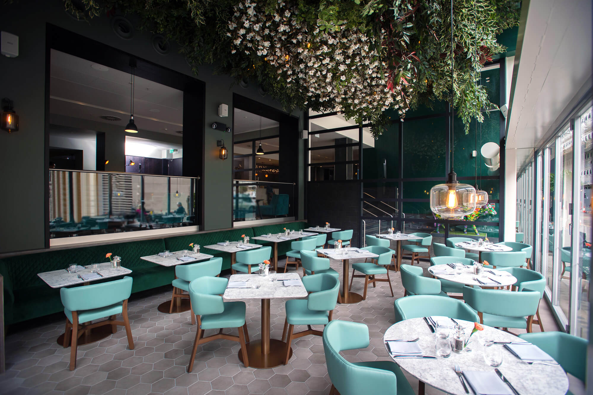 Inside Of Empty Restaurant With Floral Ceiling Decor & Blue Interior